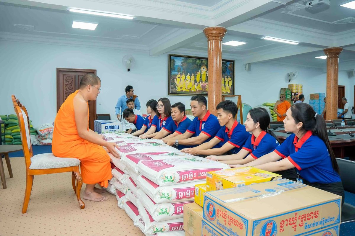 CamBright staff delivering a rice and supplies donation at a pagoda